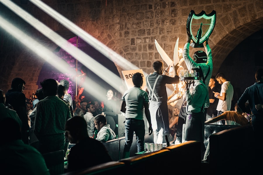 Bottle service arriving at a table under stage lights