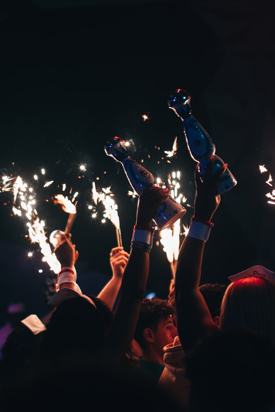 Bottles carried overhead with sparklers through a dark, crowded club